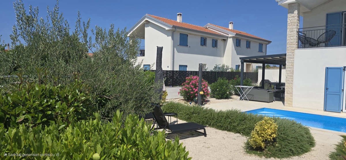 Garden with olive tree and sun lounger